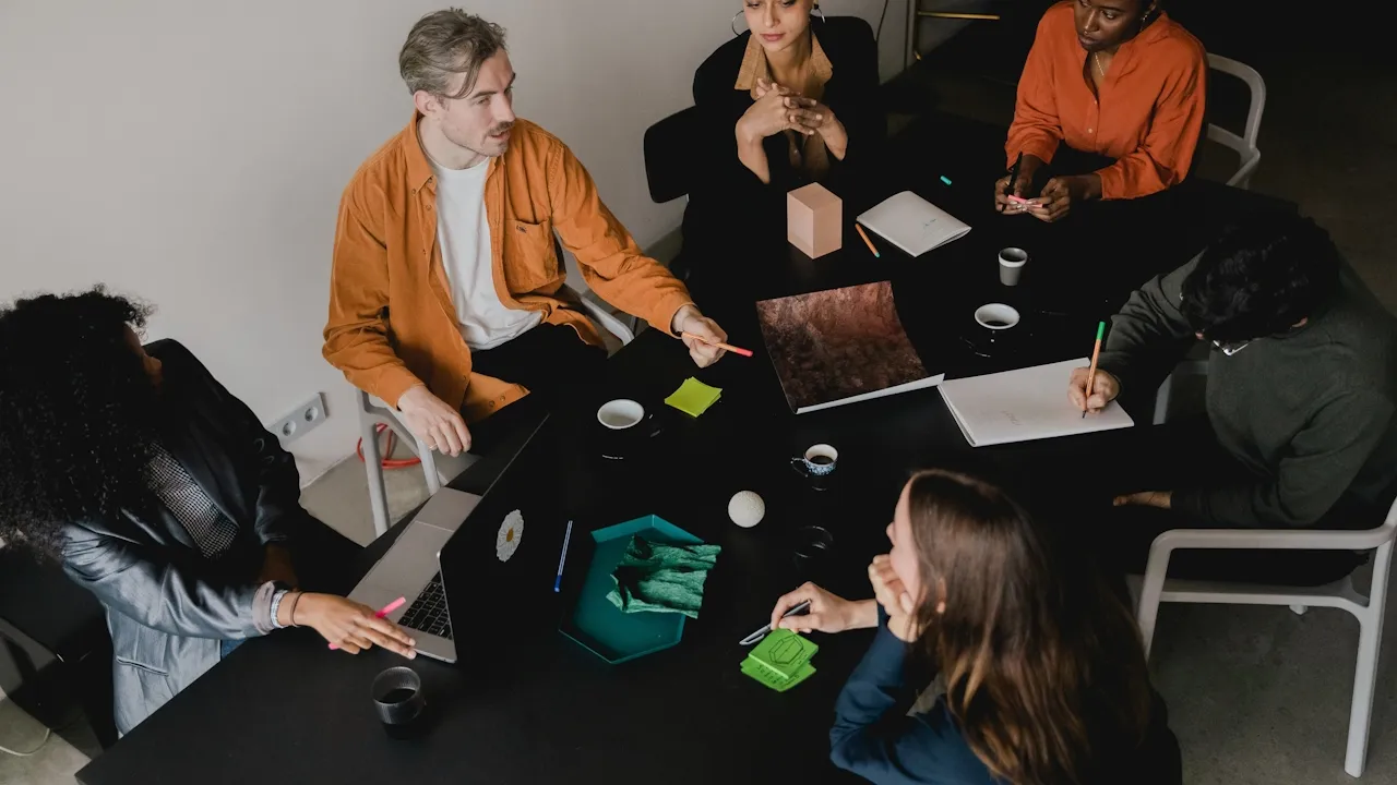 Startup team sat around a desk planning a new product