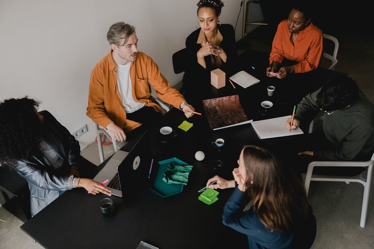 Startup team sat around a desk planning a new product